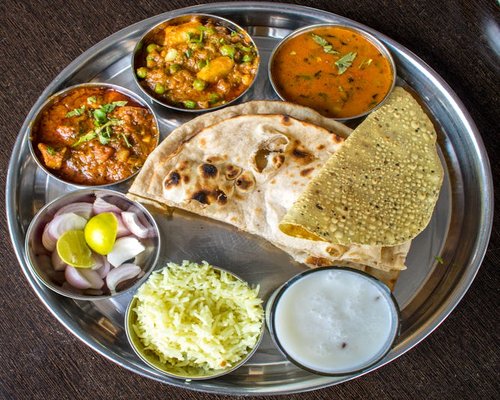 traditional indian thali setup with dal vegetables and roti
