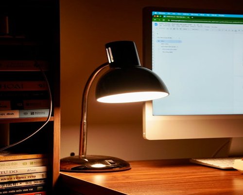 well lit modern desk workspace with a warm reading lamp